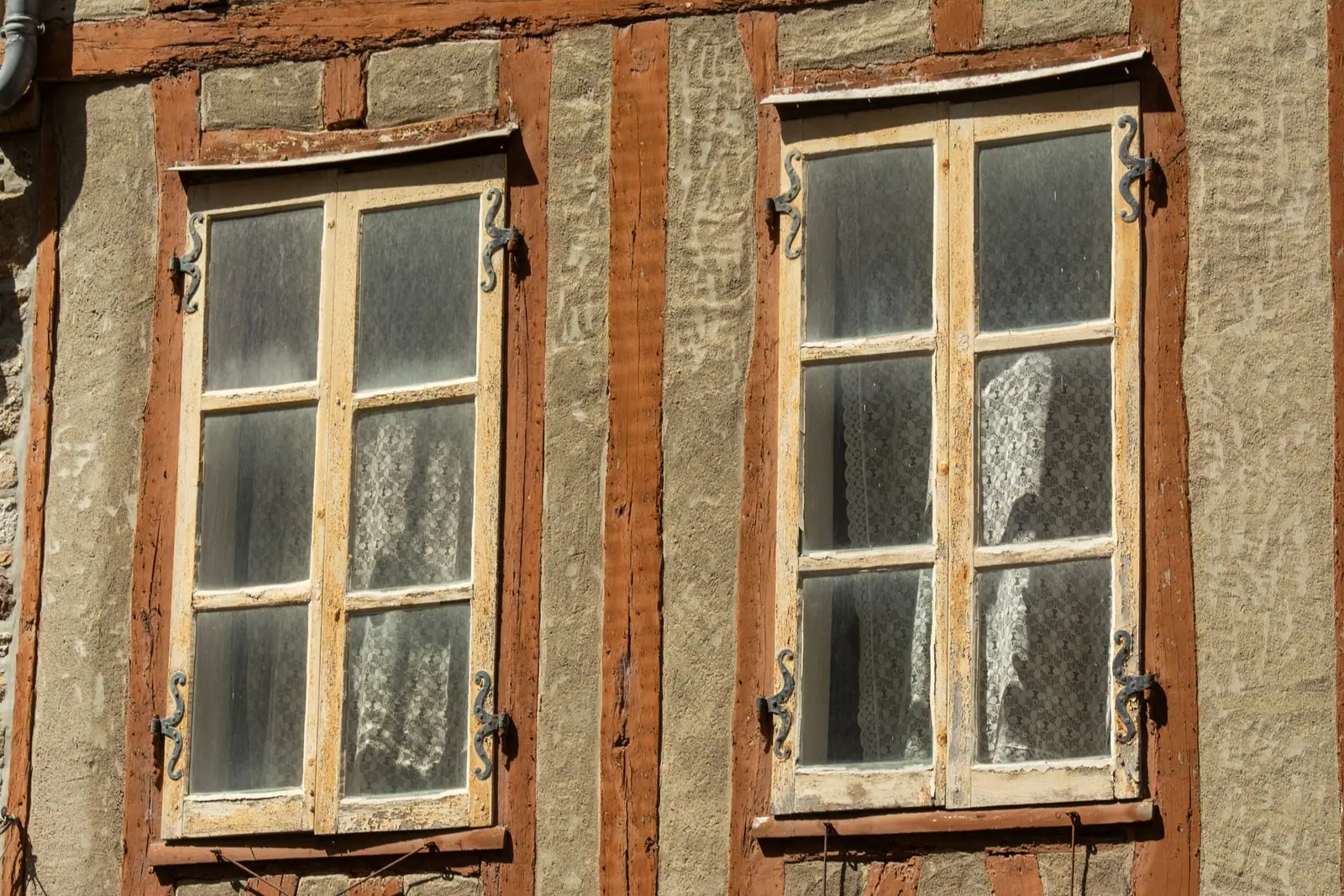 Old timber windows set into a rendered wall