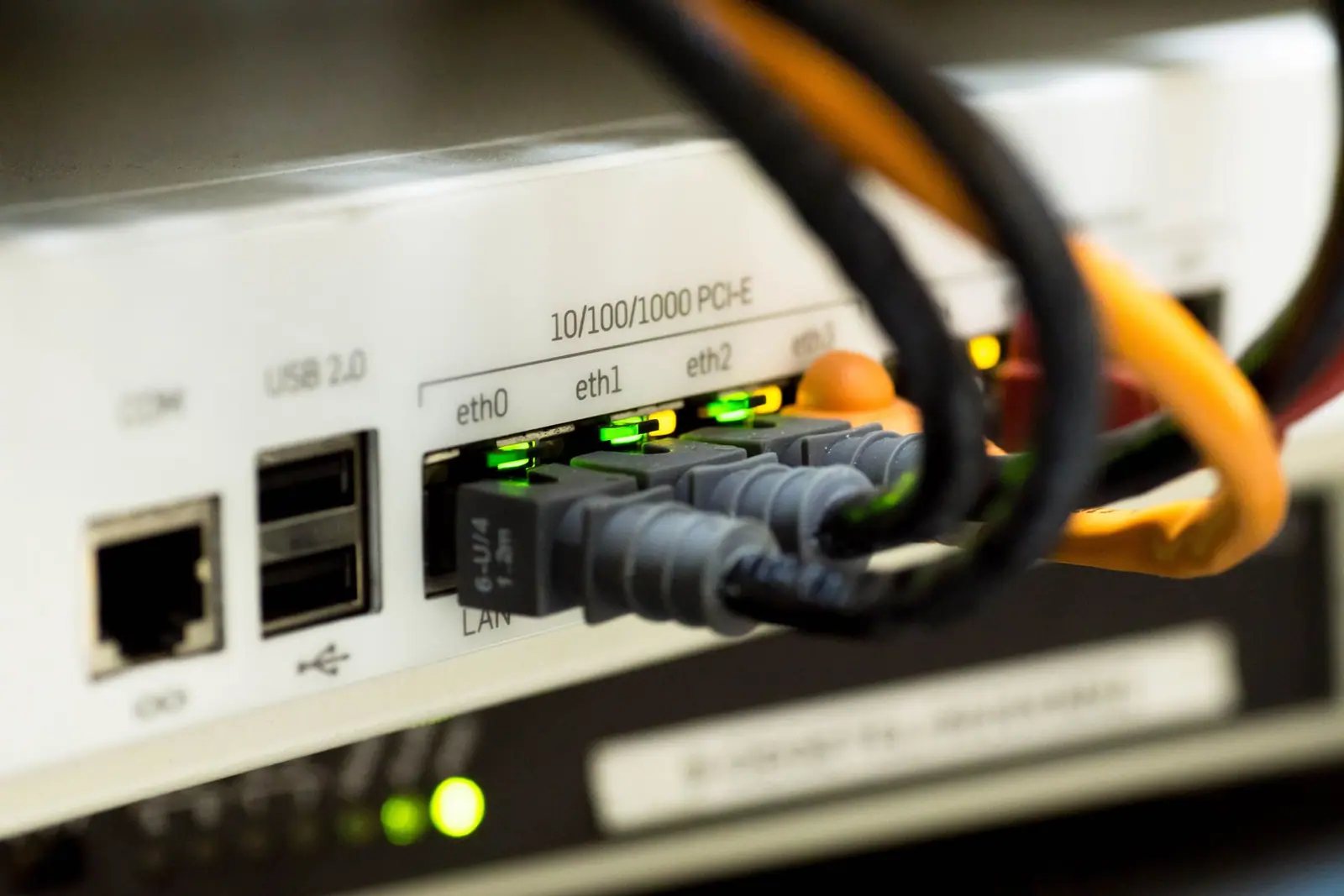 Network cables plugged into the back of a router