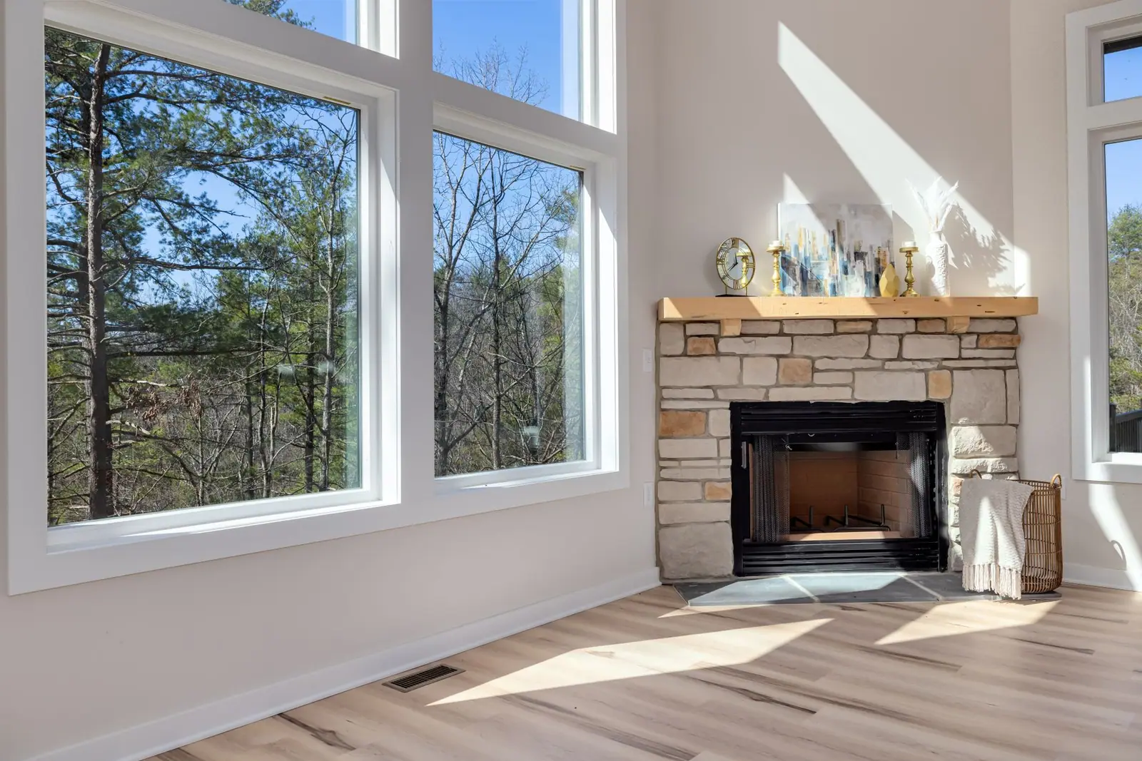 A stone fireplace surround in a bright room