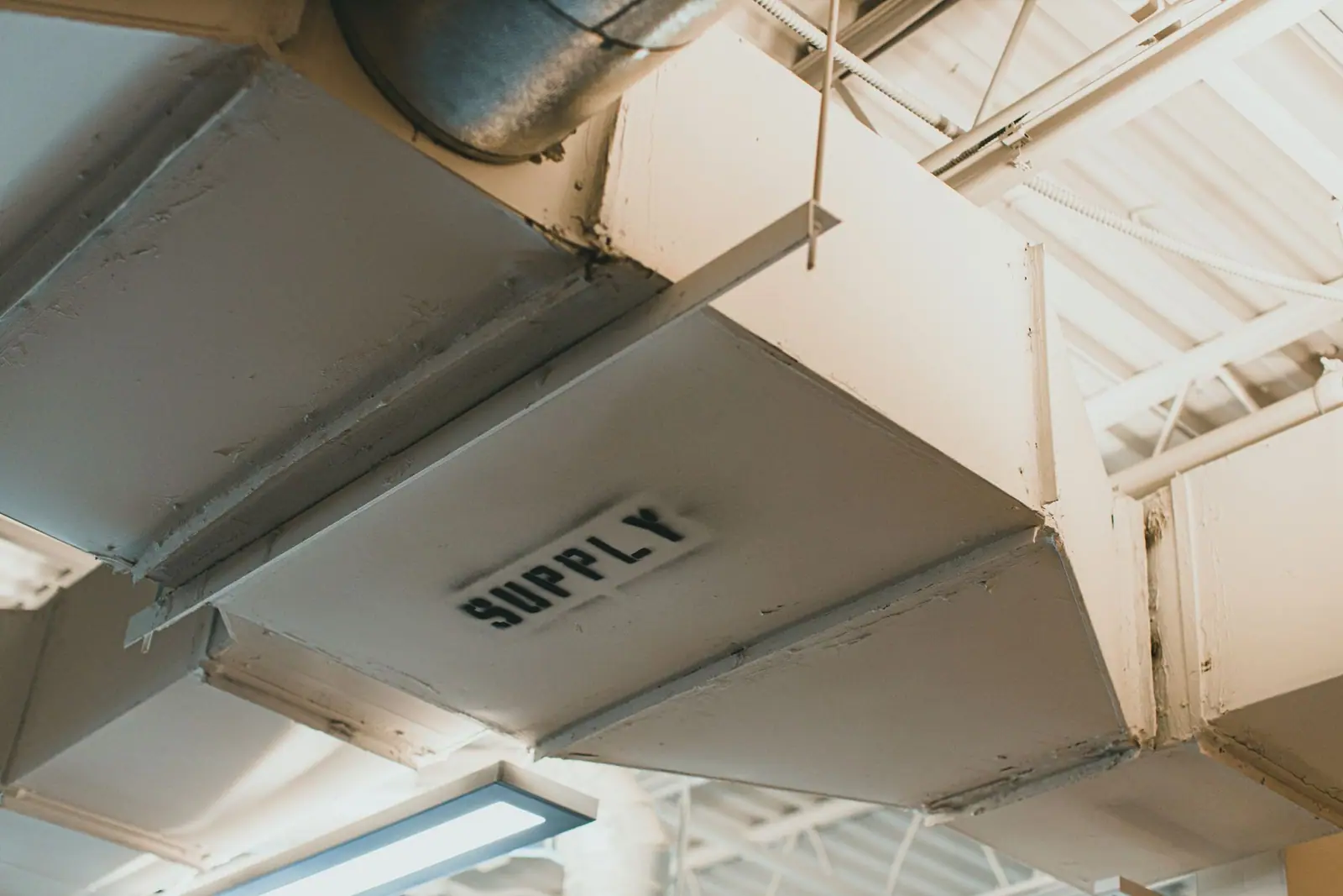 A supply air duct running along a ceiling