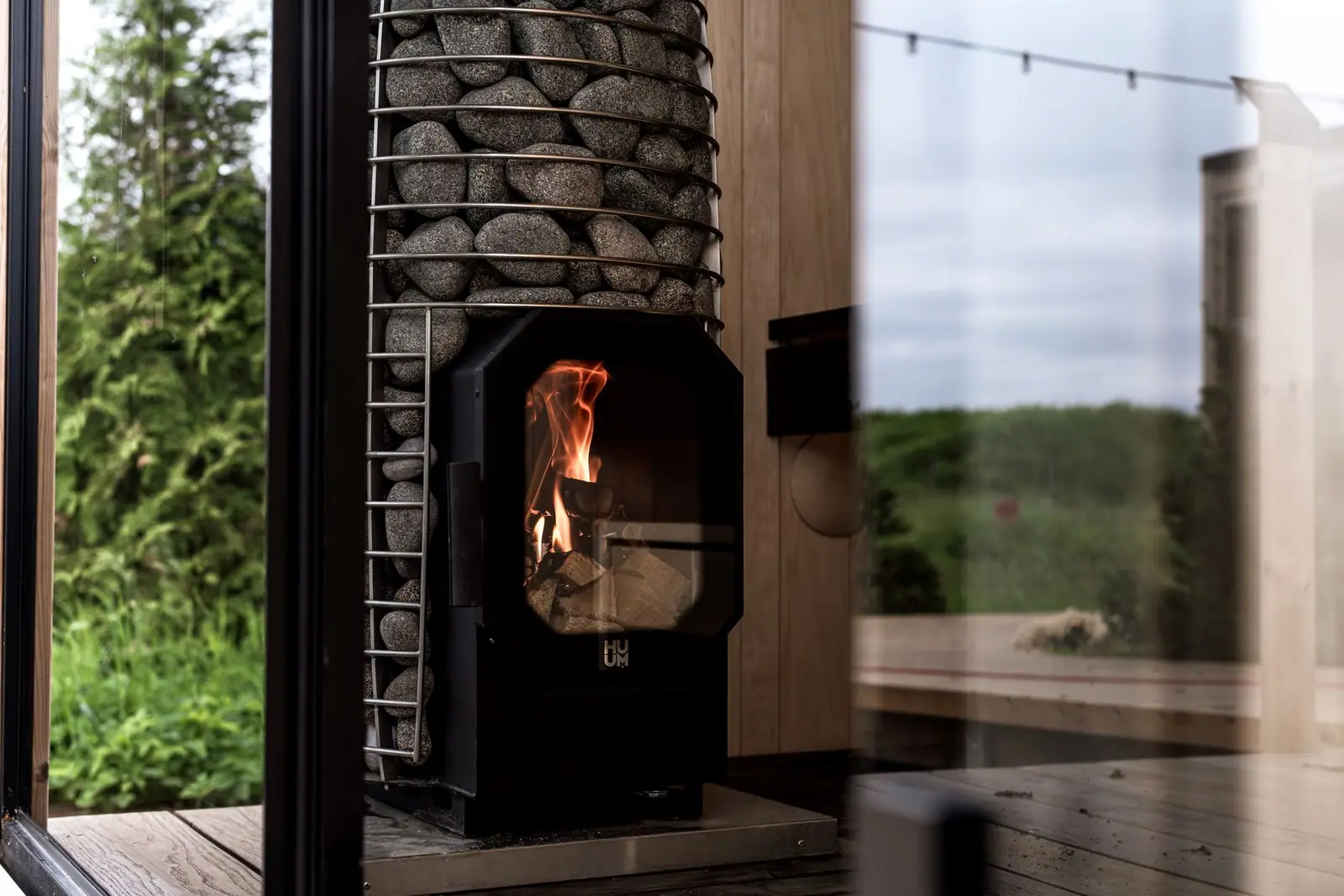A glass-fronted stove built into a stone wall