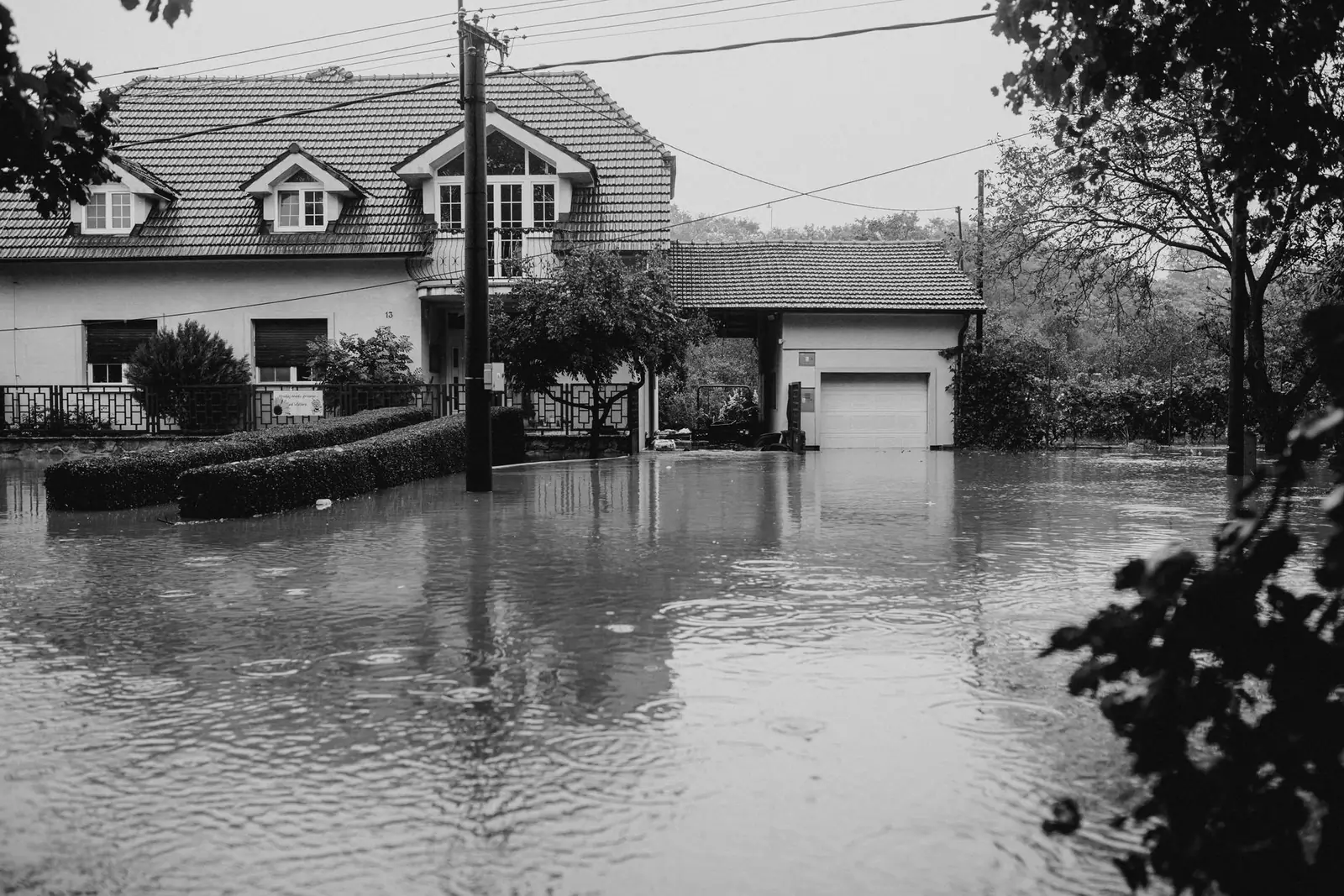 Flood water surrounding a house up to the garage door
