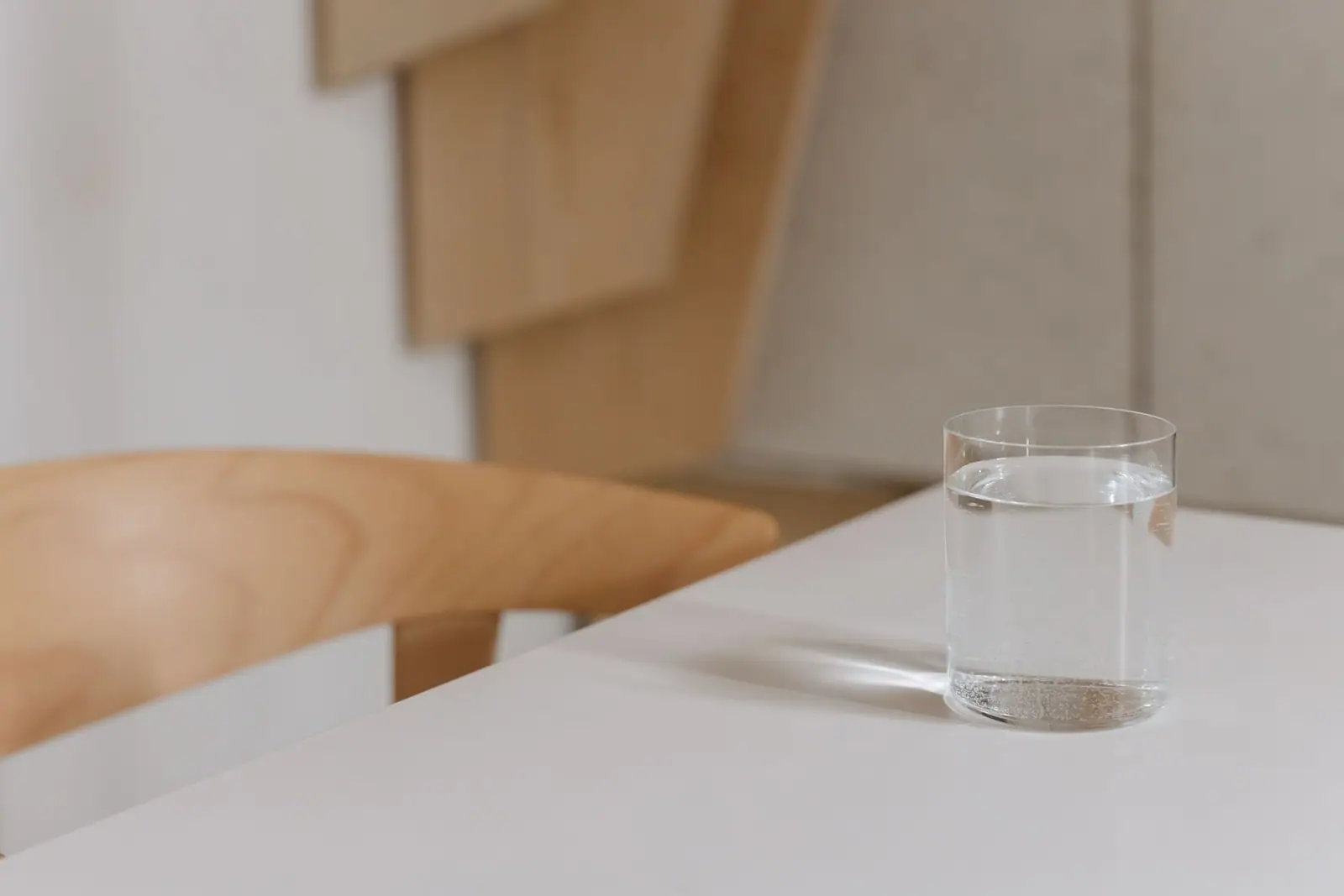 A glass of water on a wooden table