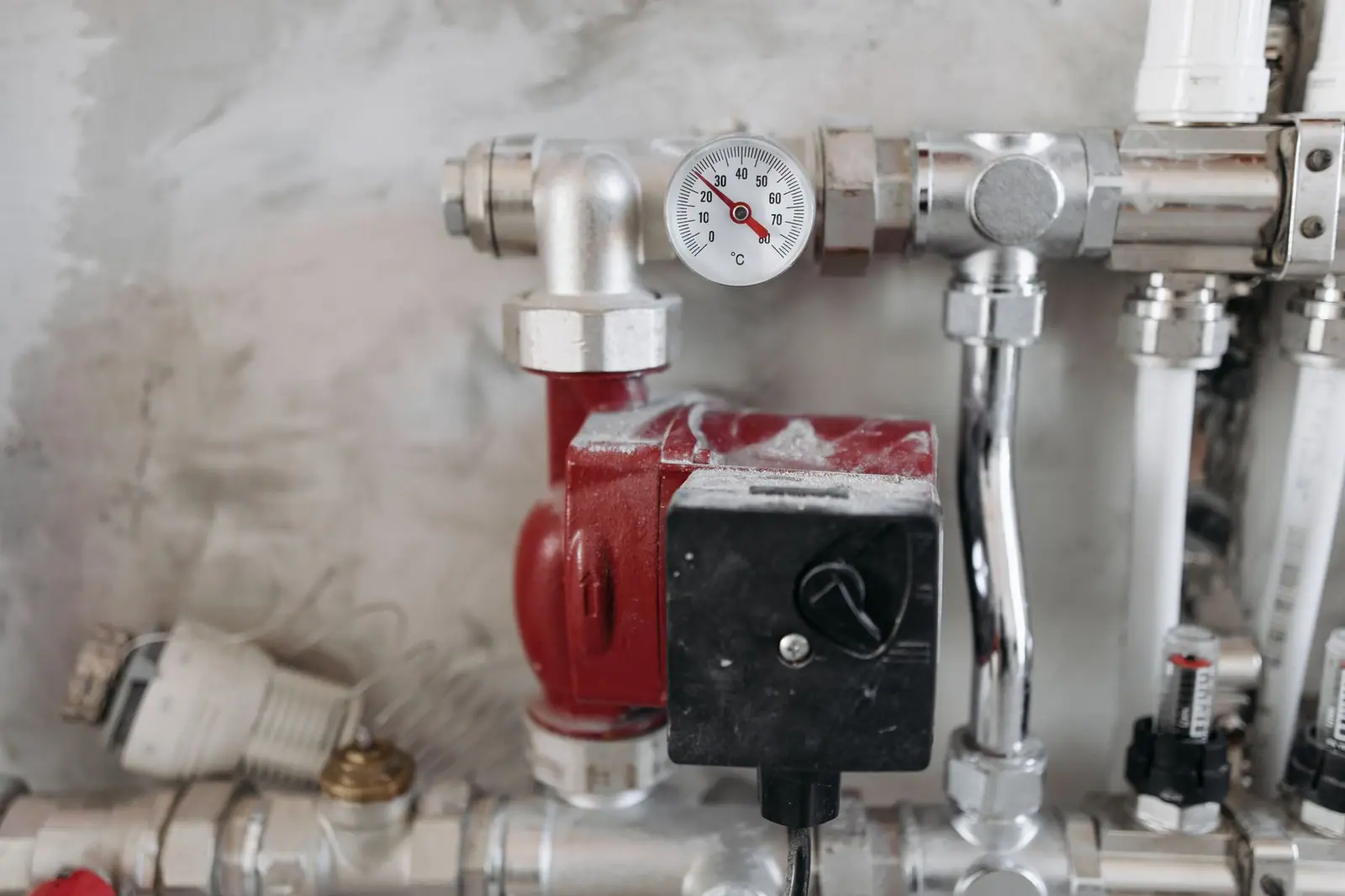 A pressure gauge on steel pipework