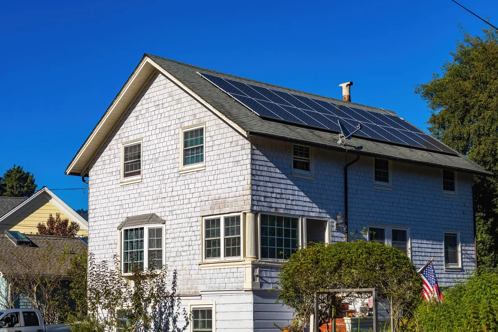 Solar panels fitted to the roof of a white house
